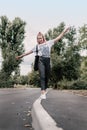 Young teenager hipster girl with pink hair goes along the curb line. Young girl goes his own way Royalty Free Stock Photo