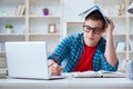 The young teenager preparing for exams studying at a desk indoors Royalty Free Stock Photo