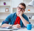 Young teenager preparing for exams studying at a desk indoors Royalty Free Stock Photo