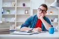 The young teenager preparing for exams studying at a desk indoors Royalty Free Stock Photo