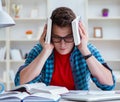 Young teenager preparing for exams studying at a desk indoors Royalty Free Stock Photo