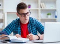 Young teenager preparing for exams studying at a desk indoors Royalty Free Stock Photo