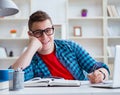 Young teenager preparing for exams studying at a desk indoors Royalty Free Stock Photo