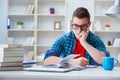 The young teenager preparing for exams studying at a desk indoors Royalty Free Stock Photo