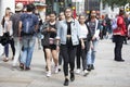 A young teenagers girls walks along Carnaby Street. Carnaby Street is one of the main shopping streets of London.