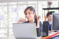 Young telephone operator with headset, Customer service executive team working at office Royalty Free Stock Photo