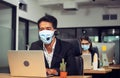 Young telephone operator with headset wear protection face mask against coronavirus, Customer service executive team working at Royalty Free Stock Photo