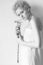 Young tender curly girl with a plant in his hands.