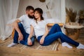 Young Tender Enamoured Couple In Jeans Spending Time Together Sitting On The Floor At Home