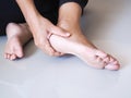 Thai asian women ache and pain with foot, heel pain symptom