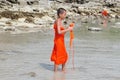 Young Thai Buddhist novice enjoys the beach in Thailand