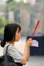 Young Thai lady praying at the Trimurti Shrine, Lover`s shrine, God of Love Royalty Free Stock Photo