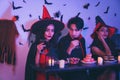 Young Thai People in Costumes Celebrating Halloween. Group of Young Happy Friends Wearing Halloween Costumes having Fun at Party Royalty Free Stock Photo