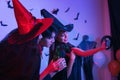 Young Thai People in Costumes Celebrating Halloween. Group of Young Happy Friends Wearing Halloween Costumes having Fun at Party Royalty Free Stock Photo