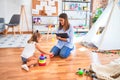 Young therapist woman speaking and treating child, counselor and behaviour correction at pedagogue payroom taking notes on