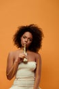 Young thoughtful african american woman with artistic make-up drinking milk from bottle Royalty Free Stock Photo