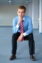 Young thoughtful businessman in blue shirt