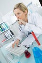 Young thoughtful female chemist working in lab Royalty Free Stock Photo