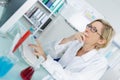 Young thoughtful female chemist working in lab Royalty Free Stock Photo