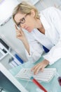 Young thoughtful female chemist working in lab Royalty Free Stock Photo