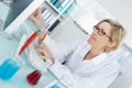 Young thoughtful female chemist working in lab Royalty Free Stock Photo