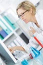 Young thoughtful female chemist working in lab Royalty Free Stock Photo