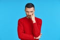 Young thoughtful man thinking and looking to camera with copy space, isolated on blue background Royalty Free Stock Photo