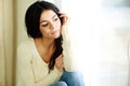 Young thoughtful woman looking at window