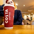 Young Thoughtful Woman Sitting In Costa Coffee Shop