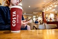 Young Thoughtful Woman Sitting In Costa Coffee Shop