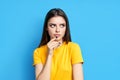 Young thoughtful woman thinking and looking aside on copy space isolated on blue background Royalty Free Stock Photo