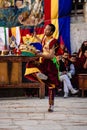 Young Tibetan Buddhist in traditional outfit clothing performing Dance at the Tiji Festival in Nepal