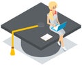 Young tiny girl in glasses sitting with laptop on graduation student hat, higher education online