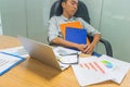 Young tired businessman falling asleep at unorganized workplace