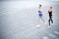 Young woman and man jogging in city copy space Royalty Free Stock Photo