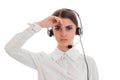 Young tired business woman in uniform with headphones and microphone looking at the camera isolated on white background Royalty Free Stock Photo