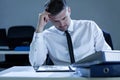 Young, tired businessman reading notes