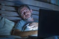 Young Tired And Exhausted Internet Or Work Addict Man Sleeping While Networking Late Night With Laptop On Bed In Overwork Or