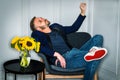 Young tired man with beard, relaxing, thinking inside at home in New York City