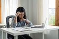 Young tired stressed overworked businesswoman freelancer exhausted after hard work, suffering from migraine headache at Royalty Free Stock Photo