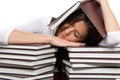 Young tired student is under and over books Royalty Free Stock Photo
