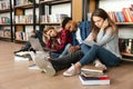 Young tired students sitting in library on floor Royalty Free Stock Photo