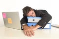 Young tired and wasted businessman working in stress at office laptop computer sleeping exhausted Royalty Free Stock Photo