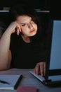 Young tired woman doing overtime job at night Royalty Free Stock Photo