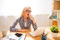 Young tired woman in glasses yawning after work with laptop Royalty Free Stock Photo