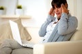 Young tired woman sitting on sofa with headache Royalty Free Stock Photo