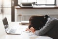 Young tired woman sleeping at office desk Royalty Free Stock Photo