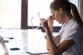 Young tired woman worker student taking off glasses, eyes fatigu Royalty Free Stock Photo