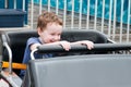 Young toddler boy having fun on boardwalk amusement ride Royalty Free Stock Photo