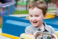 Young toddler boy having fun on boardwalk amusement ride Royalty Free Stock Photo